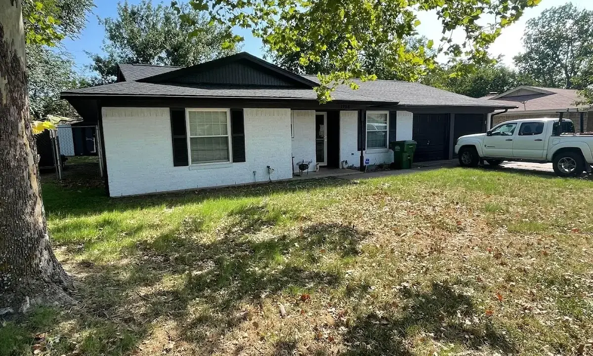 Professional roofing crew working on a residential roof in Three Lakes